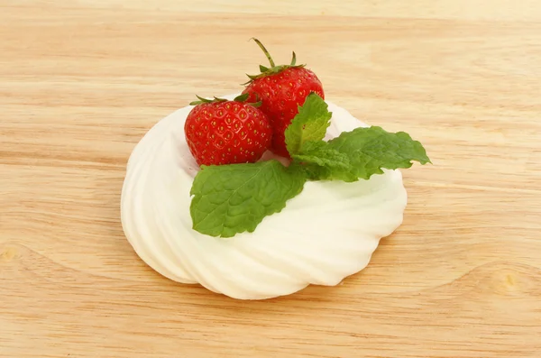 Strawberries with mint on a meringue — Stock Photo, Image