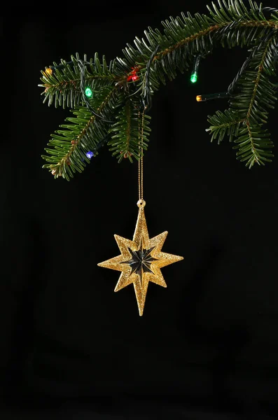 Closeup Christmas Tree Lights Hanging Gold Glitter Star Black Background — Stock Photo, Image