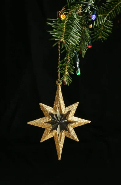 Gold Glitter Star Ornament Hanging Christmas Tree Branch Lights Black — Stock Photo, Image