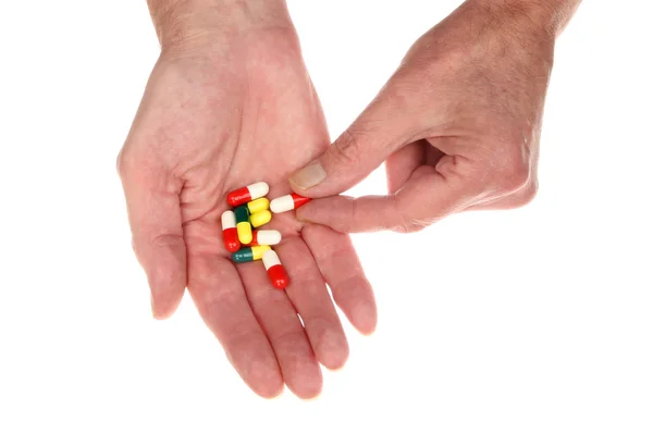 Hands holding pills — Stock Photo, Image