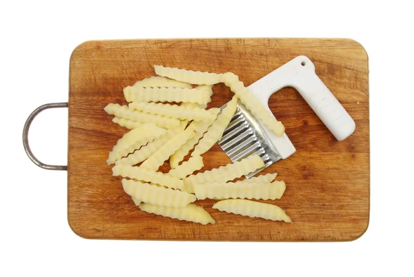 Raw potato chips with cutter — Stock Photo, Image