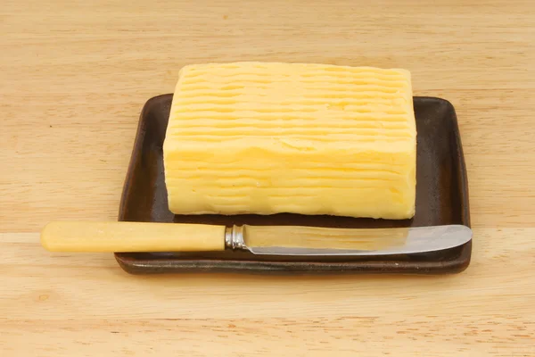 Block of butter and knife — Stock Photo, Image