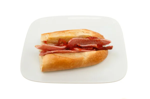 Bacon baguette with tomato ketchup — Stock Photo, Image