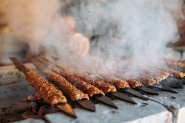 Traditional Turkish grilled shish kebab or kebap. Delicious Adana kebab on black background.