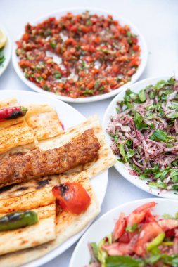 Traditional Turkish grilled shish kebab or kebap. Delicious Adana kebab on black background.