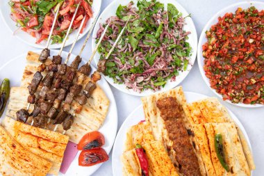 Traditional Turkish grilled shish kebab or kebap. Delicious Adana kebab on black background.