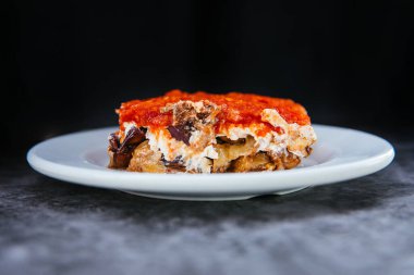 Traditional Turkish or Greek eggplant meze or appetizer on black background.
