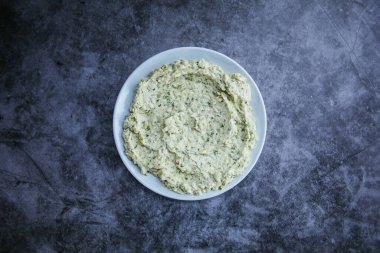 Traditional Turkish or Greek yoghurt or yogurt meze or appetizer on black background.