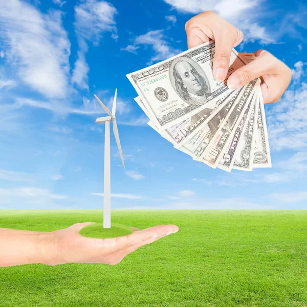 Hand holding wind turbine and US Dollars banknote — Stock Photo, Image