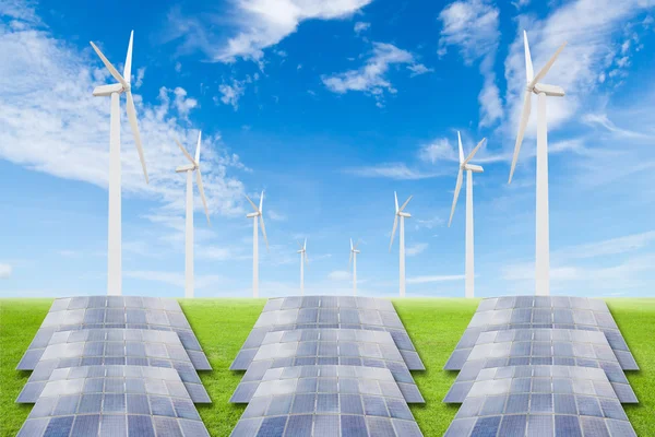 Solar panels and wind turbine on green grass field against blue — Stock Photo, Image