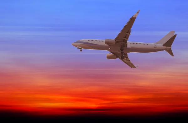 Commercial airplane flying at sunset — Stock Photo, Image