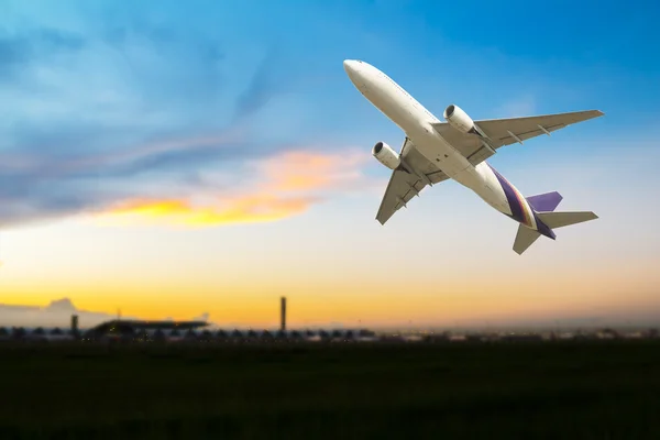 Commercial airplane take off at sunset — Stock Photo, Image