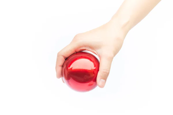 Hand auf glänzend rotem Ball auf weißem Hintergrund — Stockfoto