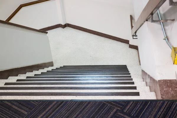 Empty office staircase vanishing downstairs — Stock Photo, Image