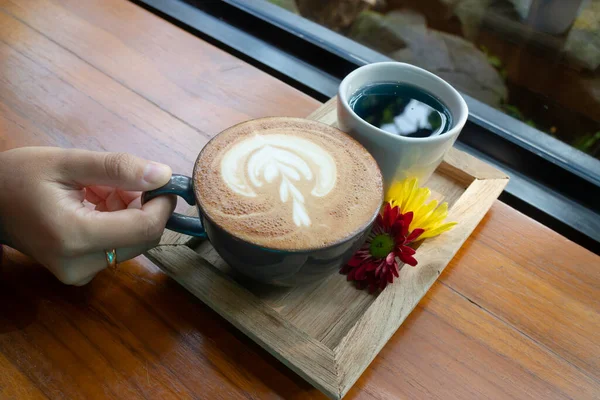 Latte coffee art cup in the garden, stock photo