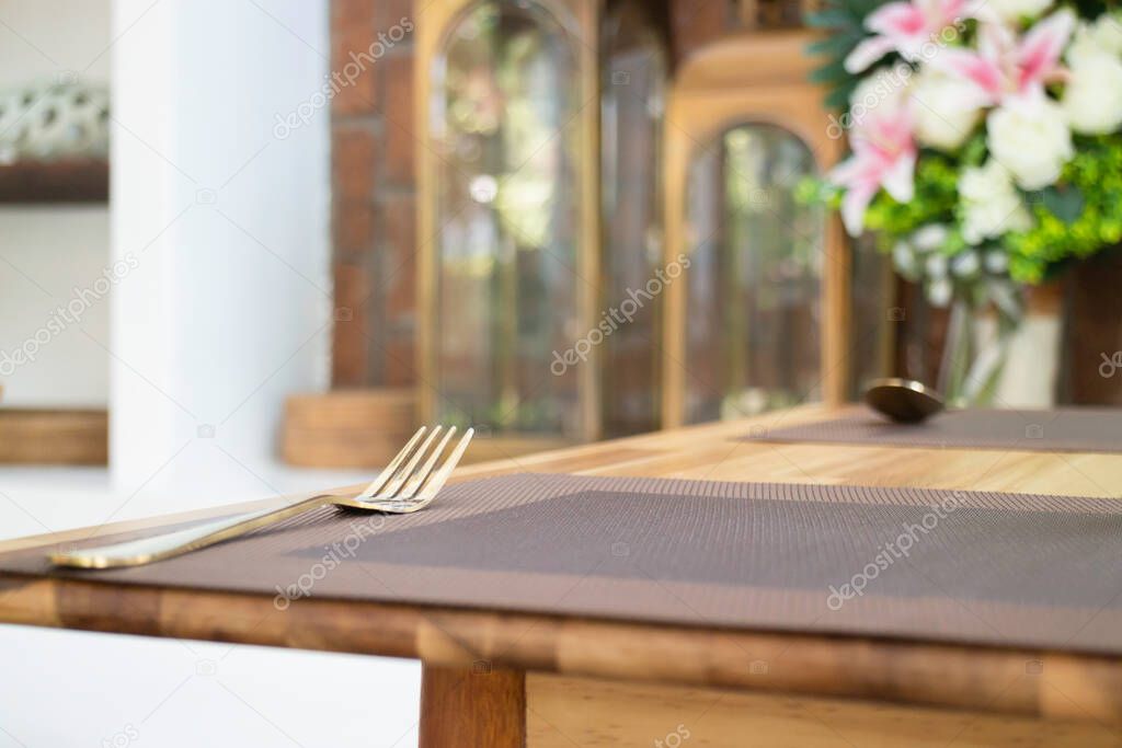 Golden metal fork on dining table, stock photo