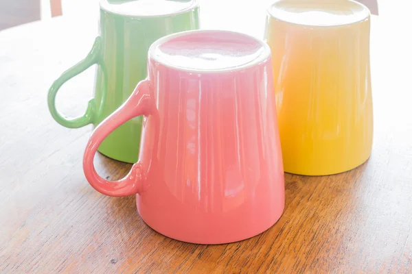 Coloridas tazas de cerámica sobre mesa de madera —  Fotos de Stock