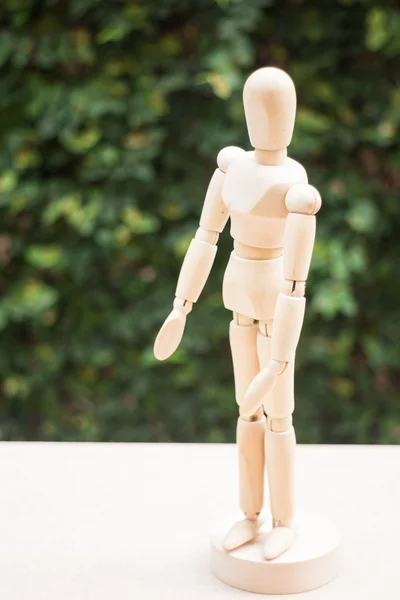 Wooden artist manikin pose on the table — Stock Photo, Image