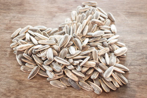 Sunflower seeds on weathered wood — Stock Photo, Image