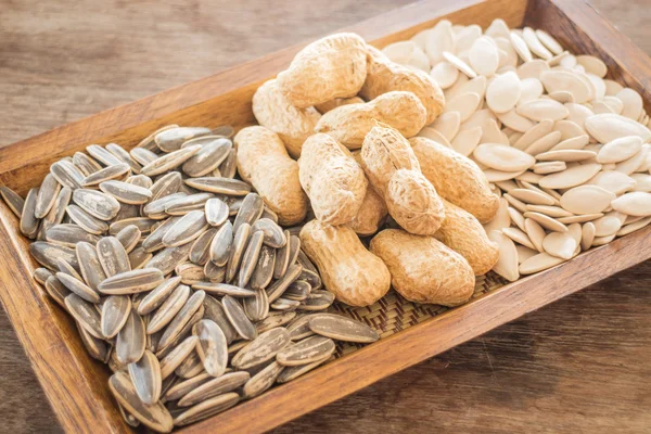 Assorted of whole grain sunflower, peanut and pumpkin on wooden — Stock Photo, Image