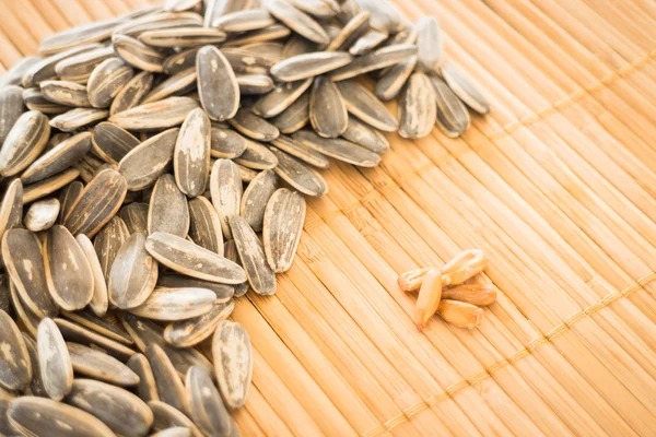 Sunflower seeds on kitchen mat — Stock Photo, Image