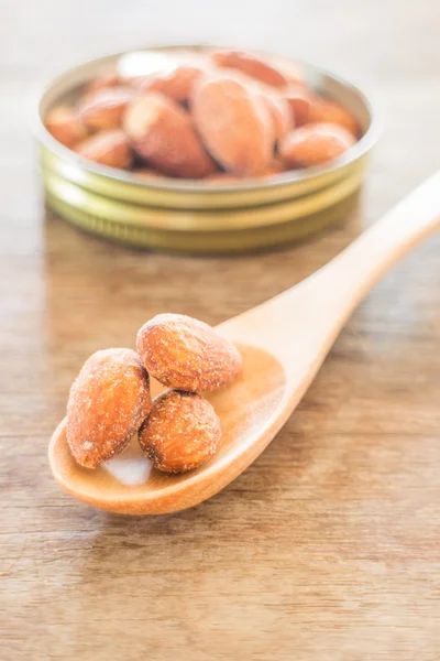 Almond grain roast salt on weathered wooden table — Stock Photo, Image