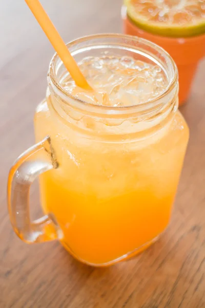 Fresh orange juice serving on wooden table — Stock Photo, Image