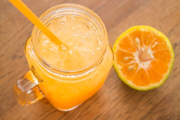 Fresh orange juice serving on wooden table — Stock Photo, Image