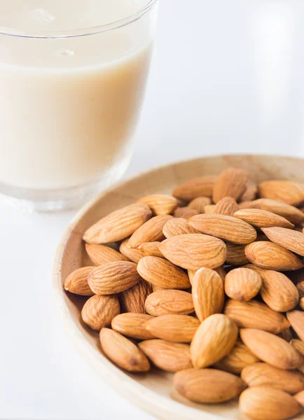 Almond milk and grain on white kitchen table — Stock Photo, Image