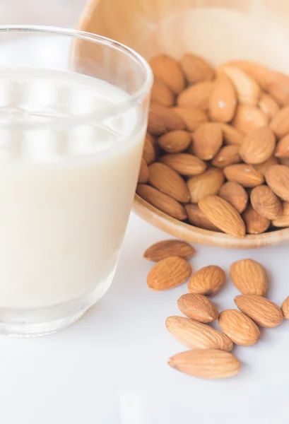 Almond milk and grain on white kitchen table — Stock Photo, Image