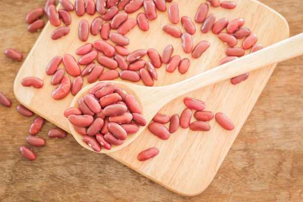 Raw red kidney bean on wooden table — Stock Photo, Image