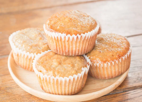 Homemade banana muffins on wooden plate — Stock Photo, Image