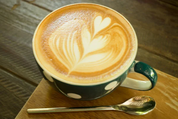Latte Art Kaffeetasse auf Holztisch — Stockfoto
