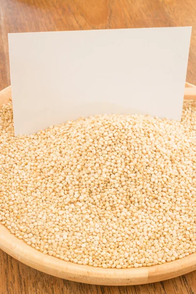 Organic quinoa grain and business card — Stock Photo, Image