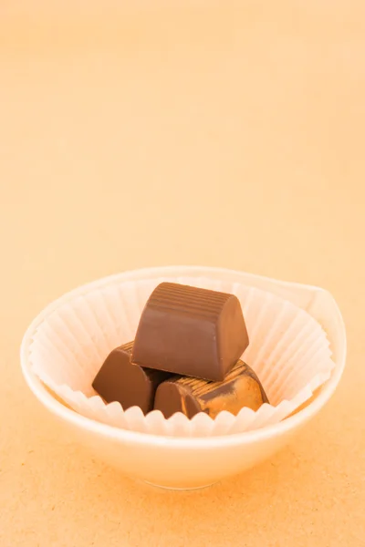 Chocolate pieces on on warm vintage background — Stock Photo, Image