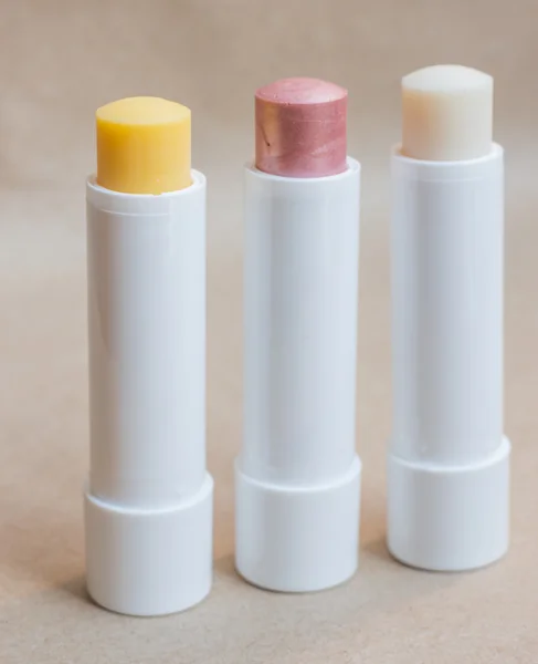 Moisturizer lipstick on brown natural background — Stock Photo, Image