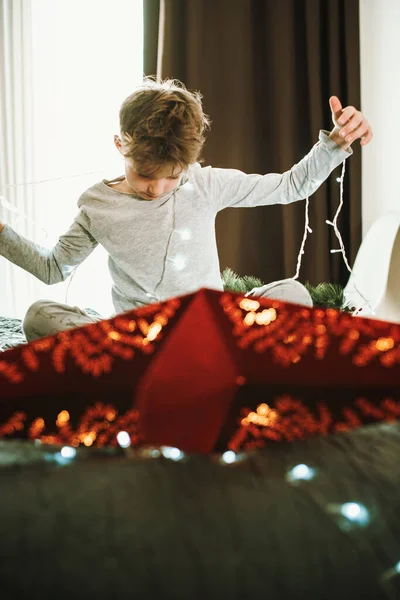 Boy Decorating Home Window Christmas Garland Red Star Magic Winter — Stock Photo, Image