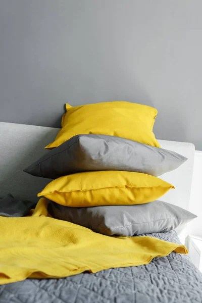 Color pillows illuminating ultimate gray pile on bed Two trendy 2021 colors of years Modern interior design Cozy textile Sweet home