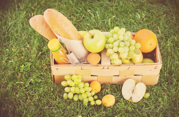 Picnic Wattled Basket with Fresh Food. Imagen tonificada — Foto de Stock