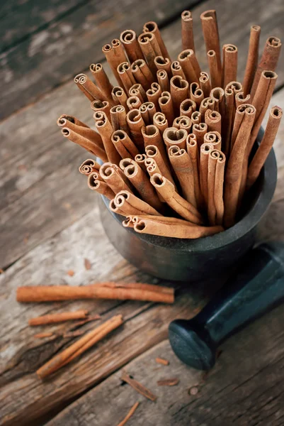 Mortar with Cinnamon Sticks on Wooden Table — Stock Photo, Image