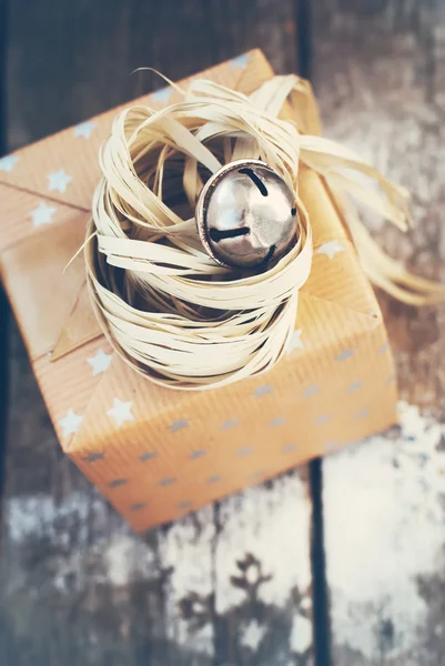 Christmas Gift with Jingle Hand Bell and Natural Twine. Toned — Stock fotografie