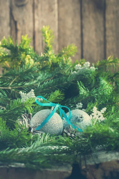 Silver Bright Balls with Snowflakes, Pine Cones and Fir Tree  on Wooden Background. Toned — Stock Photo, Image