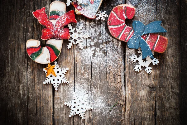 Festliches Tannenbaumspielzeug Zuckerstangen, Glocke mit Schneeflocken auf Holztisch — Stockfoto