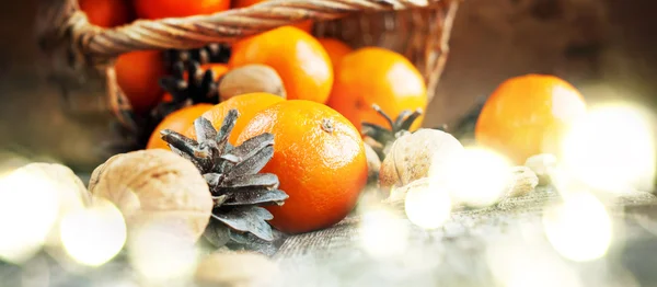 Christmas Light with Basket of Festive Food on wooden background