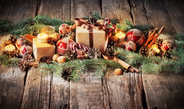 Christmas Composition with Gifts, Boxes, Pine Cones, Fir Tree Toys and Candles on Wooden Background