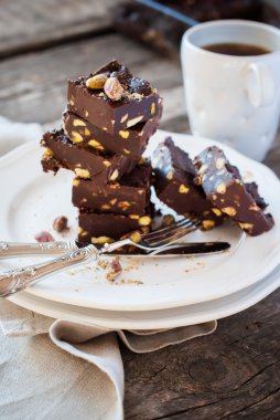 Chocolate Fudge with Pistachios on White Plate, rustic style