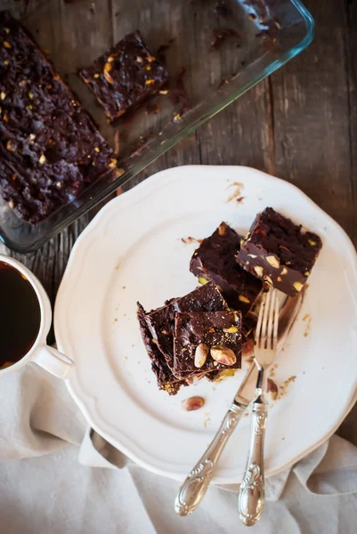 Chocolate Fudge with Pistachios on White Plate, top view — стокове фото