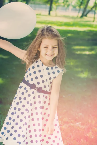 Retrato da jovem menina bonita feliz com balão branco. Tonificado — Fotografia de Stock