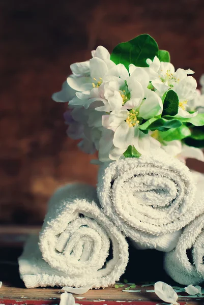 Towels put in Rolls with White Branch of the Apple Flowers — Stock Photo, Image