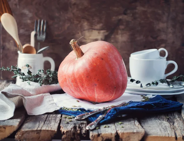 Pumpkin on a Napkin. Wooden Table with Vintage Crockery — Stock Photo, Image
